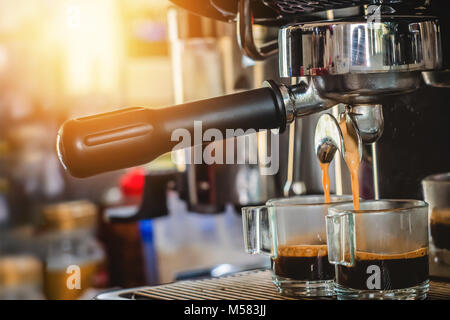Espresso machine pouring coffee in cups Stock Photo by ©bogdan