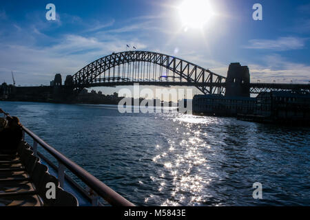 View of Sydney Harbor at sunset from a boat; fragment of the boat on the left Stock Photo