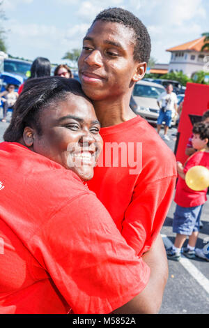 Miami Florida,Florida City,Super Chili Bowl Cook Off festival,Black man woman girl boy female male hugging,teen teens teenagers Stock Photo