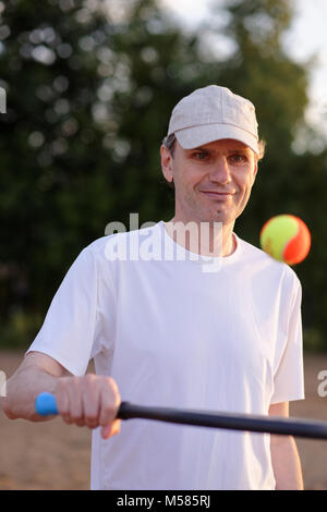 Mature man playing beach tennis on a beach Stock Photo - Alamy