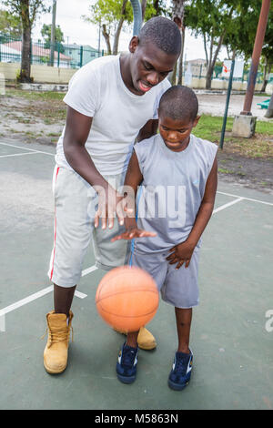Miami Florida,Liberty City,African Square Park,inner city,low income,poverty,Black man men male adult adults,boy boys,kid kids child children youngste Stock Photo