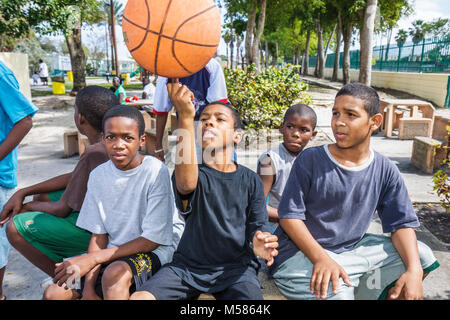 Miami Florida,Liberty City,African Square Park,inner city,low income,poverty,Black boy boys,male kid kids child children youngster,group[,park,playgro Stock Photo