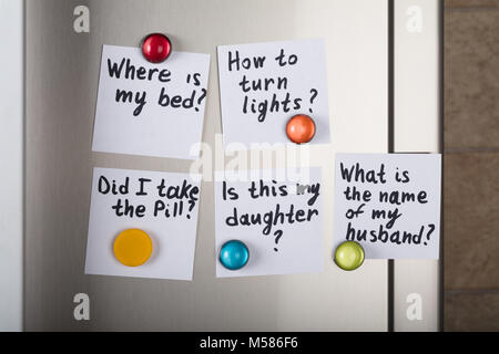 Closeup of various reminders attached with magnetic thumbtacks on metal Stock Photo
