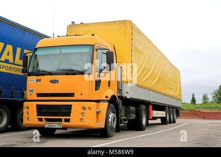 SALO, FINLAND - JUNE 14, 2014: Yellow Ford Cargo 1830 Semi trailer truck parked. Ford Cargo trucks were originally launched in 1981 by Ford of the UK, Stock Photo