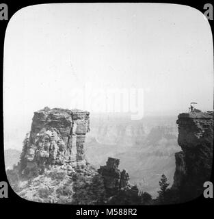 Grand Canyon Matthes Survey of . BLACK AND WHITE GLASS LANTERN SLIDE,VIEW OF GRAND CANYON WITH MAN AND PLANE TABLE STATION IN MIDDLE DISTANCE. SILVER METALLIC FRAME AROUND SLIDE RED PAPER STAR IN CORNER. CIRCA 1902. WITH A GROUP OF SLIDES FROM THE MATTHES SURVEY EXPEDITION IN THE GRAND CANYON - CIRCA 1902. Stock Photo