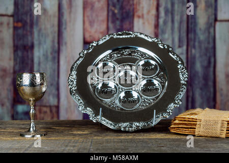 Jewish holidays Passover Pesach matzah and a silver cup full of wine with a traditional blessing Stock Photo