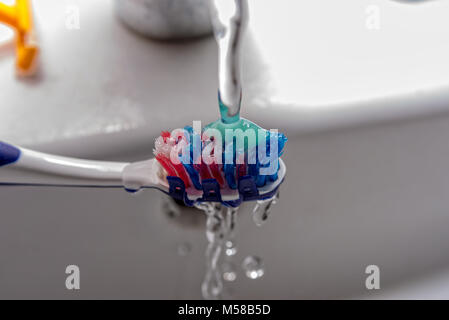 Toothbrush with toothpaste and water from the faucet