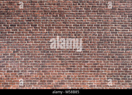 Old wall texture with lots of different red and grey points. Not uniform and needs to be washed. Stock Photo