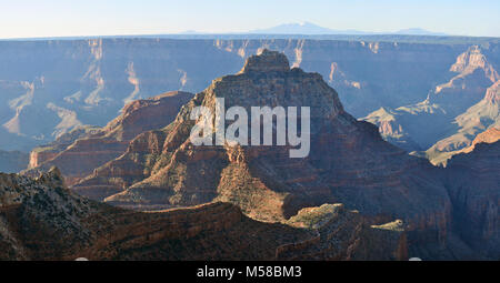 Grand Canyon National Park North Rim Vishnu Temple . Sunrise view from Angel's Window Overlook, just east of Cape Royal on the North Rim of Grand Canoyn National Park. The San Franciso Peaks (by Flagstaff, Arizona) are visible in the distance. NPS Stock Photo