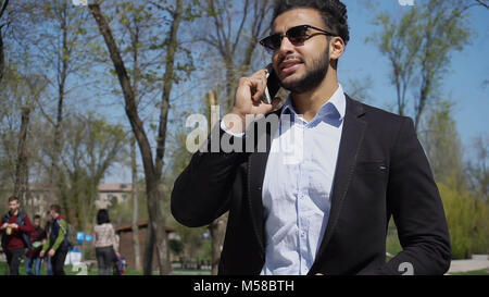 Arabian talking online with travel agent.  Stock Photo