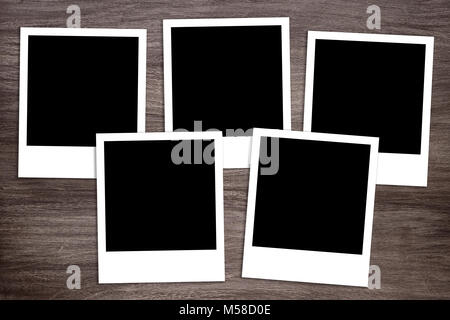 five blank instant photo print templates on wooden background Stock Photo