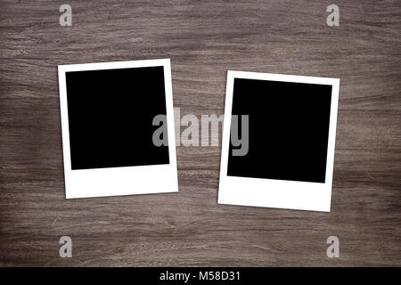 two blackened instant photo print templates on wooden background Stock Photo
