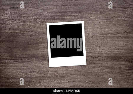 blackened instant photo print template on wooden background Stock Photo