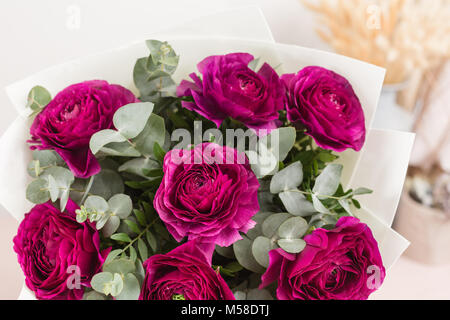 Persian buttercup. lace with many petals. Bunch violet ranunculus flowers light background. Wallpaper