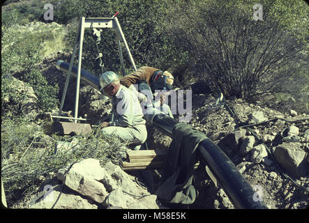 Trans canyon Pipeline (Historic) . Contractor's welding crew fabricating waterline joint before 1966 flood. Circa 1965. NPS Stock Photo