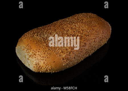 Bread bread sliced with sesame seeds on a black background.loaf Stock Photo