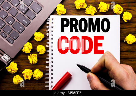 Conceptual hand writing text caption Promo Code. Business concept for Promotion for Online Business Written on tablet laptop, wooden background busine Stock Photo