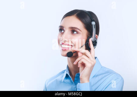 Indian businesswoman working in call center and looking up Stock Photo