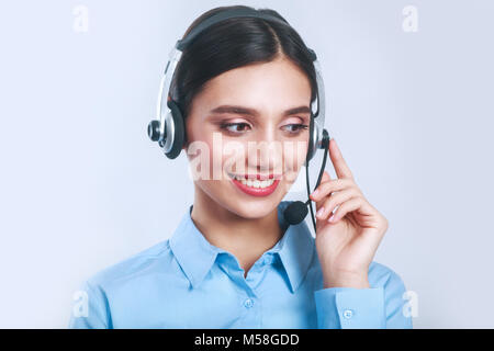 Indian businesswoman working in call center and looking down Stock Photo