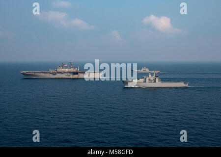 180218-N-XK809-530  GULF OF THAILAND (Feb. 18, 2018) The amphibious assault ship USS Bonhomme Richard (LHD 6), the Royal Thai Navy landing platform dock ship HTMS Angthong (LPD 791), near, and the Republic of Korea amphibious landing ship ROKS Cheon Ja Bong (LST-687) are in formation during a Cobra Gold 2018 photo exercise. Bonhomme Richard is participating in CG-18 alongside Royal Thai Navy ships and personnel, conducting a range of amphibious operations that will enhance the tactical expertise of participants and rehearse combined capabilities to respond to contingencies. The annual exercise Stock Photo