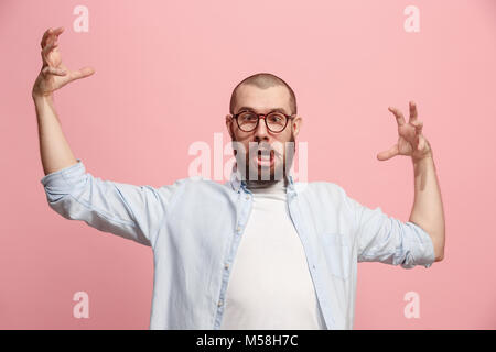 Portrait of an angry man looking at camera isolated on a pink background Stock Photo