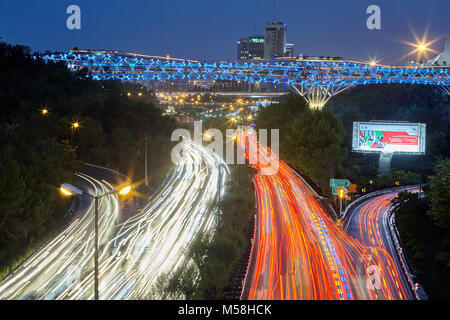 Tehran, Iran - April 29, 2017: Tabiat Bridge with evening illuminated crossed Modares highway at twilight with car light trail. Stock Photo