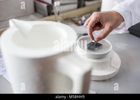 Hands of a scientist working in modern chemistry/physics lab (shallow DOF; color toned image) Stock Photo