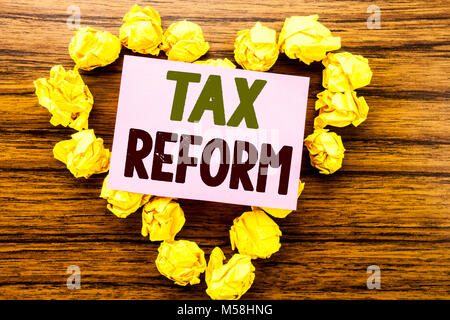 Word, writing Tax Reform. Business concept for Government Change in Taxes written on sticky note paper on wooden background. Stock Photo