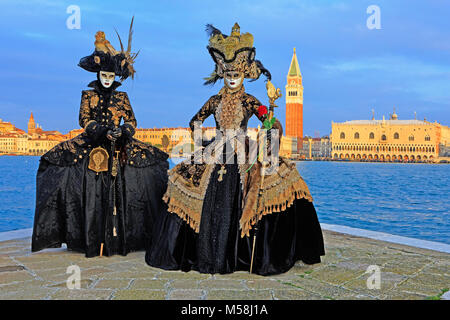 Two gracious ladies in traditional Venetian dresses during the Carnival of Venice (Carnevale di Venezia) in Venice, Italy Stock Photo