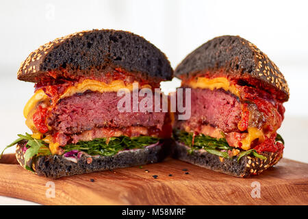 Sliced juicy cheeseburger Stock Photo