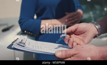 Mechanic in auto workshop takes into account the wishes of the customer to repair the car, small nusiness Stock Photo