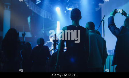 People stand near the stage during a concert Stock Photo