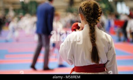 Karate girl in a white kimono with red belt ready to fight Stock Photo