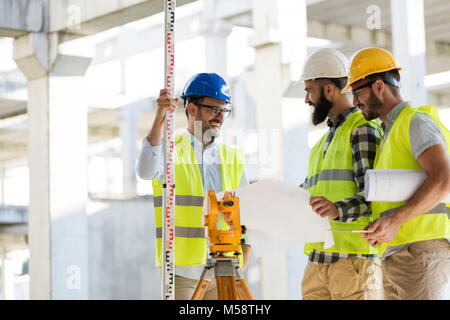 Portrait of construction engineers working on building site Stock Photo