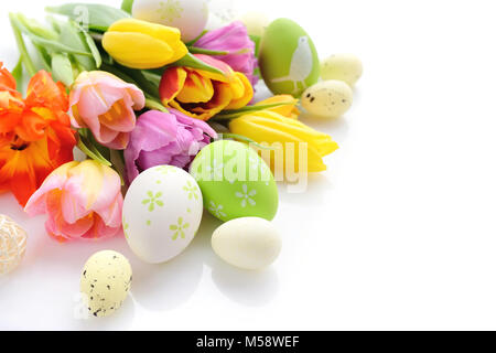 Easter eggs with tulips flowers on white background Stock Photo