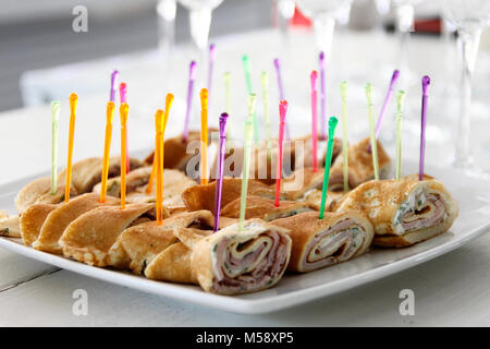 Snack for a buffet table rolls of pancakes and meat Stock Photo