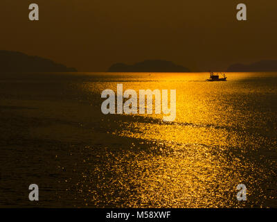 Fishing boat between Ko Chang Island and the mainland.Gulf of Thailand at sunset Stock Photo