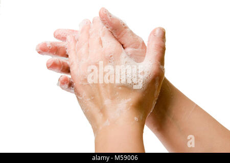 Close-up of two lather-covered female hands against white background. Stock Photo