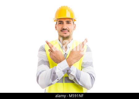 Construction builder making good luck gesture with fingers crossed on both hands smiling isolated on white background Stock Photo