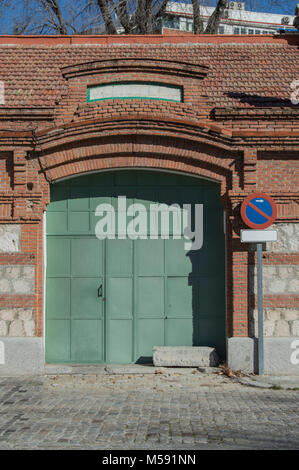 iron door in green color on a facade of a nineteenth century building in madrid. Spain. Stock Photo