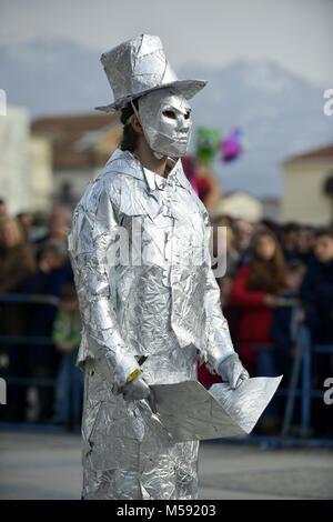 unrecognizable man wrapped with aluminium foil, holding book Stock Photo