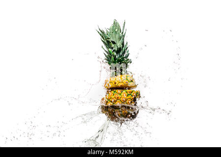 fresh sliced pineapple in water splashes isolated on white Stock Photo