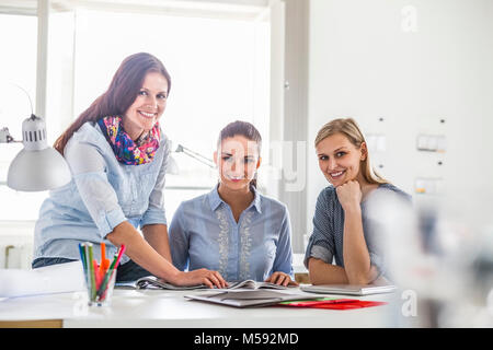Portrait of young businesswomen working together in creative office Stock Photo