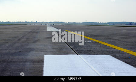 BERLIN, GERMANY - JAN 17th, 2015: Runway, airstrip on blue sky with clouds background at the Berlin Brandenburg Airport BER Stock Photo