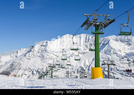 La Thuile, Italy - Feb 18, 2018: Chairlift at snow covered Italian ski area in the Alps - winter sports concept with copy space Stock Photo