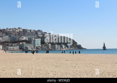 Busan, South Korea - November 11, 2017: View of t the Haeundae beach in sunny day with the high-rise buildings and tourists walking around Stock Photo