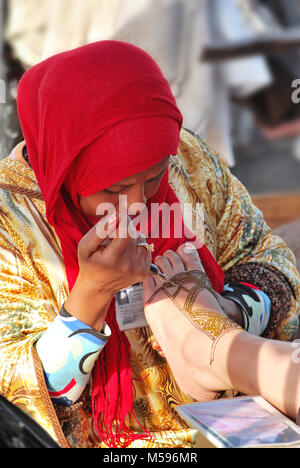 Woman applying traditional henna decoration - Moroccan henna tradition Stock Photo