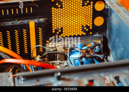 Dust on the computer pc processor cooler with mainboard and computer case fragment. Selective focus. Stock Photo