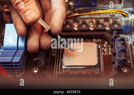 Thermal paste applied on a computer CPU. Stock Photo