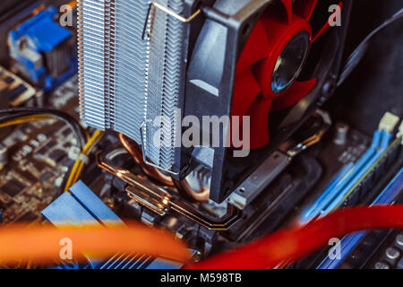 Dust on the computer pc processor cooler with mainboard and computer case fragment. Selective focus. Stock Photo